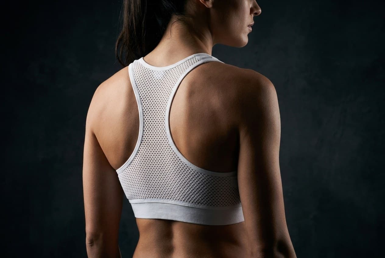 Tasteful back view showing the racerback shape and mesh ventilation panel of the AXION Vent Bra